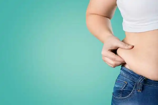 Image of woman pinching her love handles to show weight gain Berkshire